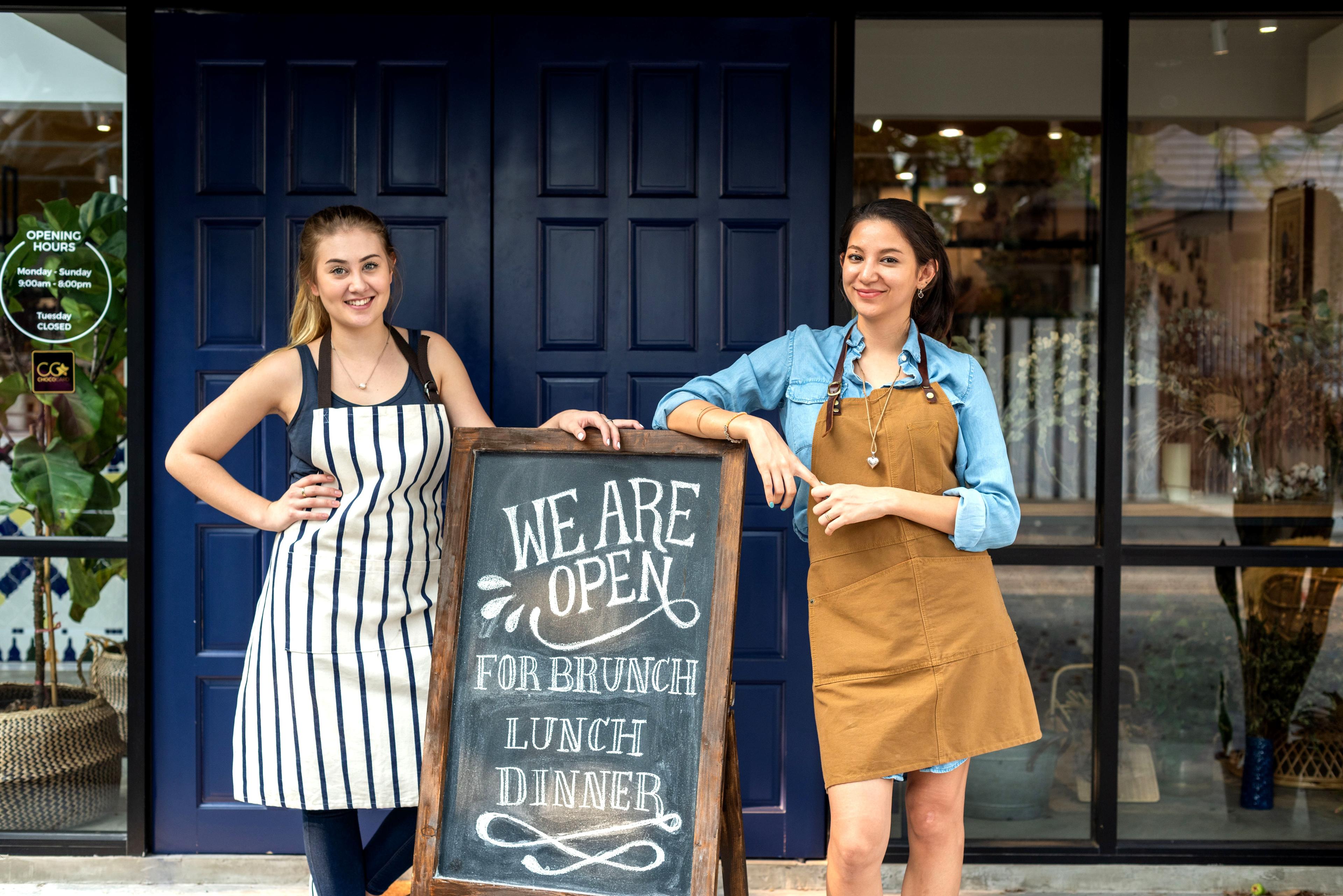 Small business owner welcoming a family